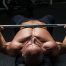 Man bench pressing in superset workout