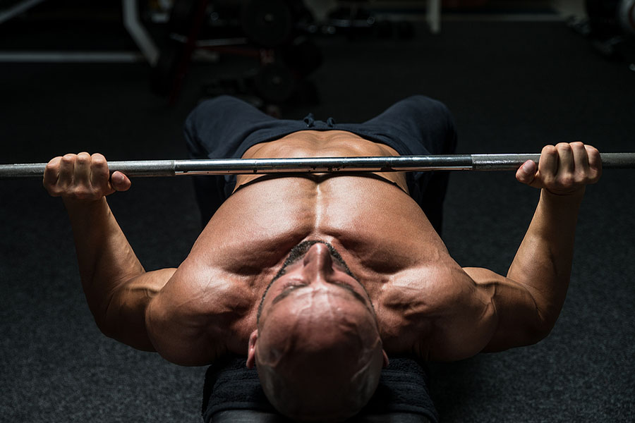 Man bench pressing in superset workout